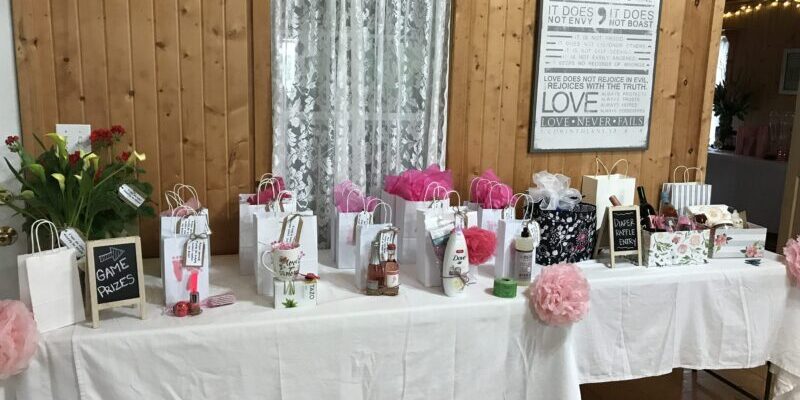 Gift table with bags and decorations displayed.