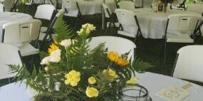 Outdoor event tent with decorated tables.