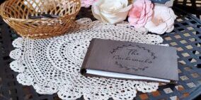 Wedding guestbook table with floral decor.