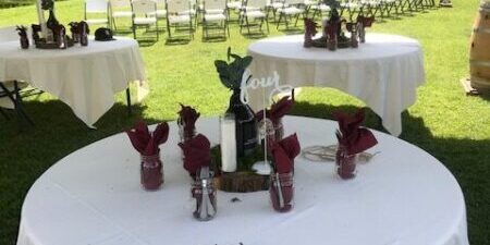 Outdoor wedding setup with decorated tables.