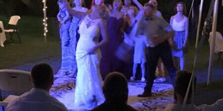 Wedding reception dance under string lights.