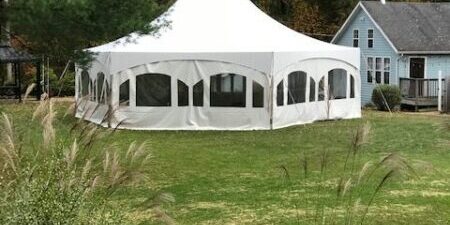 White event tent on grassy area.