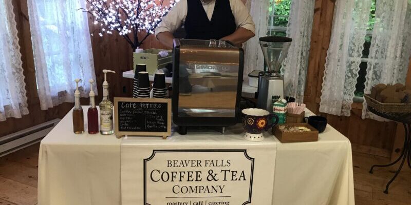 Barista preparing coffee at a catering event.