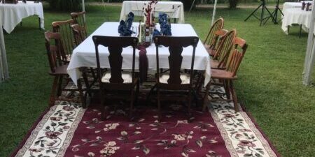 Outdoor dining setup with tables and chairs.