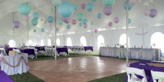 Decorated tent with tables and paper lanterns.