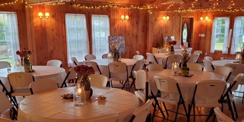 Rustic decorated room with round dining tables.