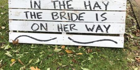 Sign reading "Come Get Cozy in the Hay.