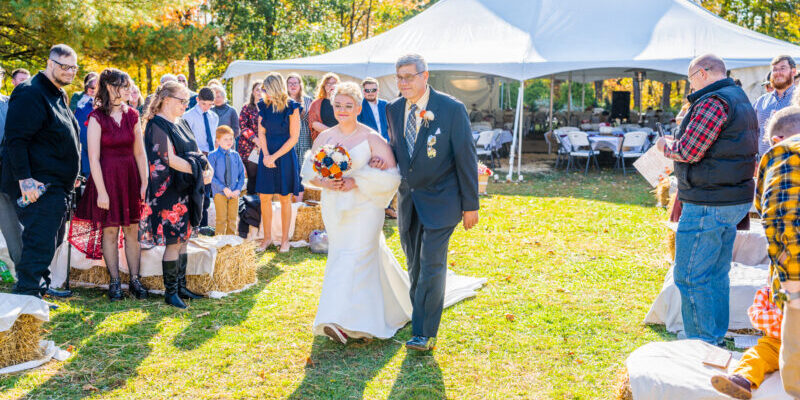 Outdoor wedding ceremony with bride and guests.
