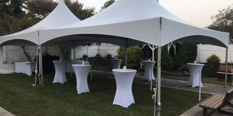 Outdoor event tents with cocktail tables.