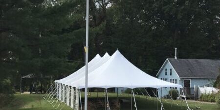 American flag, white tent, rural setting.