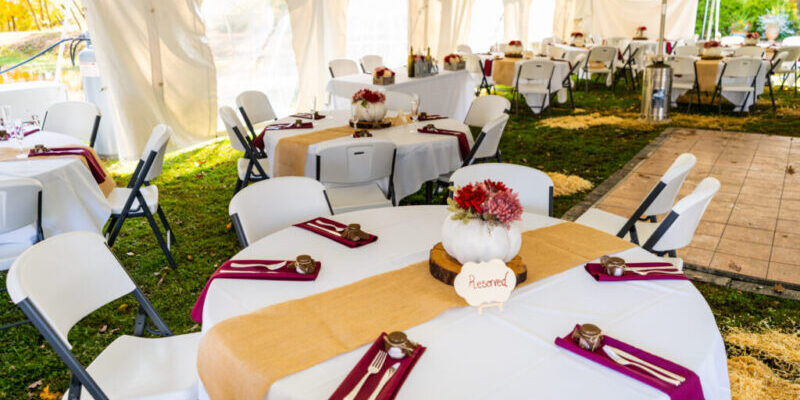 Outdoor wedding reception with decorated tables.